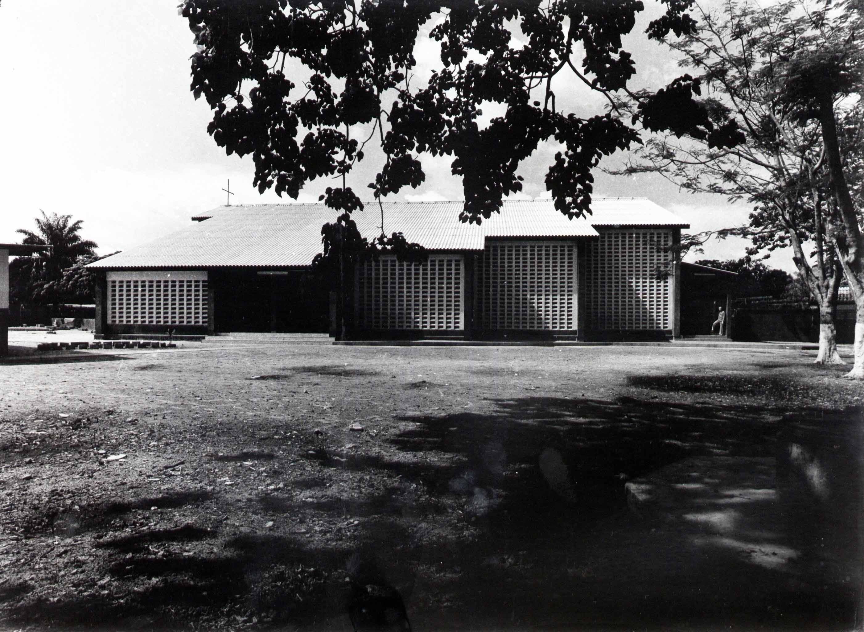A low, rectangular building with corrugated metal siding and multiple entrances.