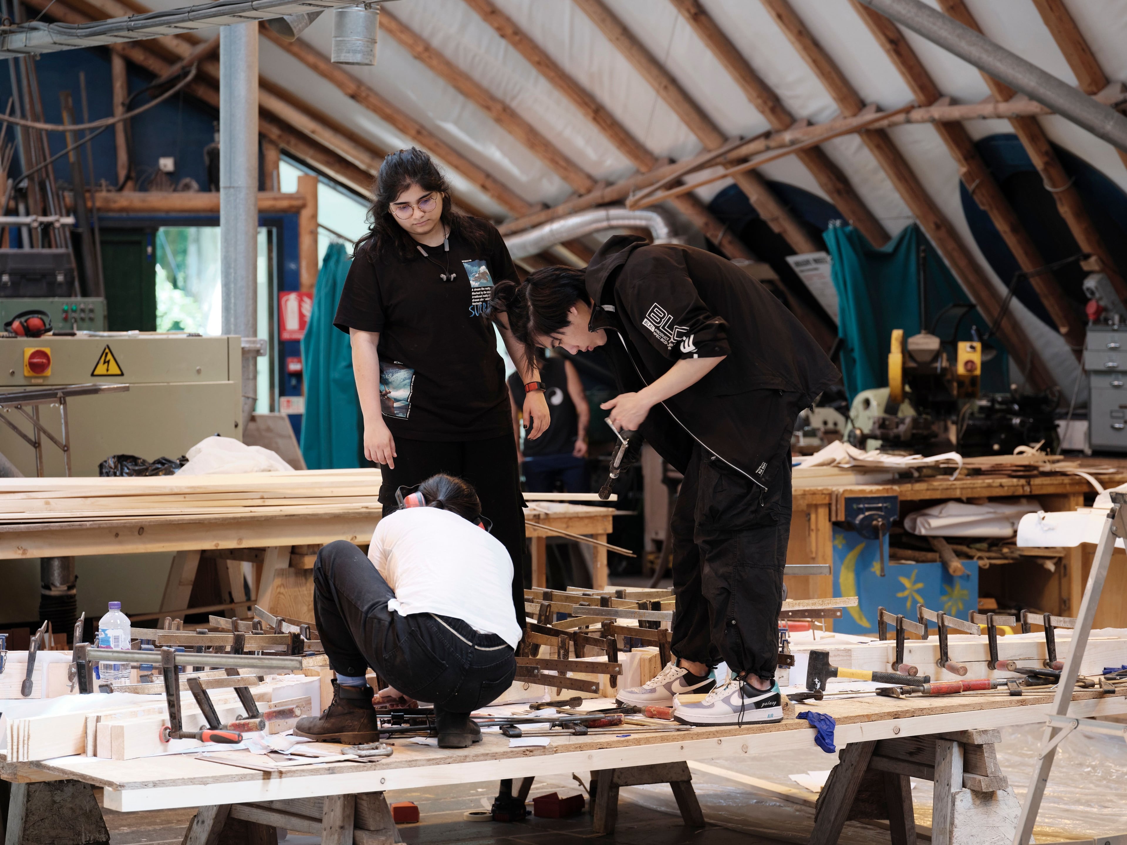 Three students working together in the Fabrication Workshop in Hooke Park, Dorset