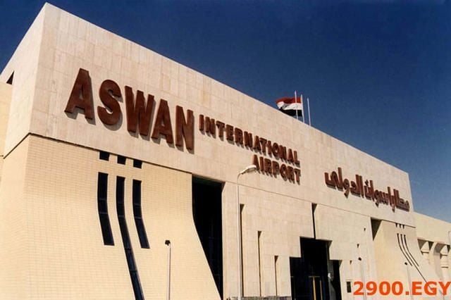 Aswan International Airport building with its name displayed prominently on the facade.