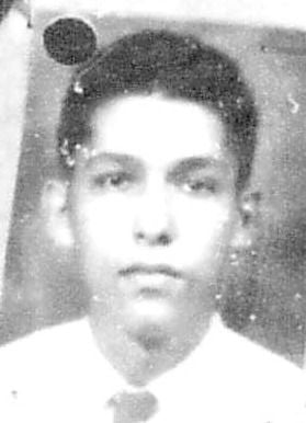 Vintage black and white headshot of a young man with dark hair and a light shirt.