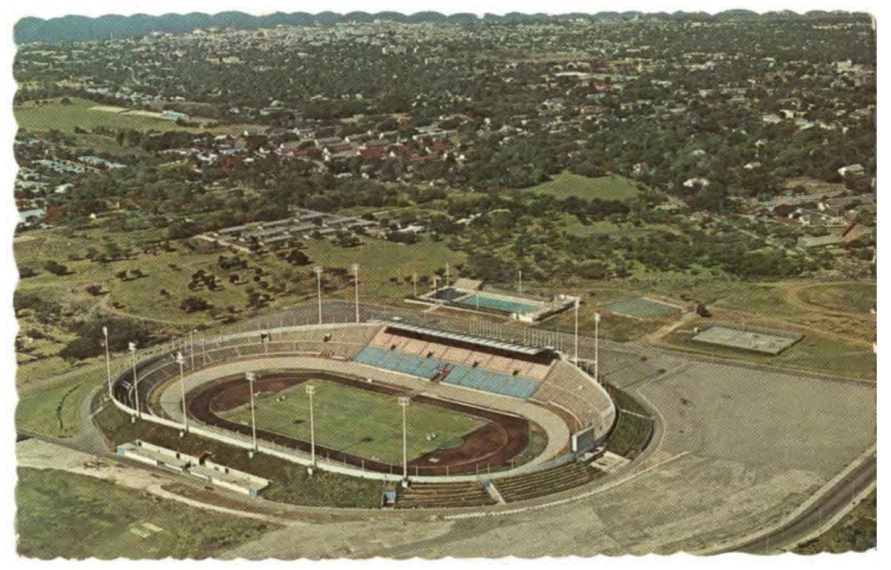 Aerial view of a large oval stadium with a track and field inside.
