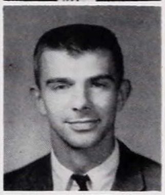 Black and white portrait of a young man with short dark hair and a slight smile.
