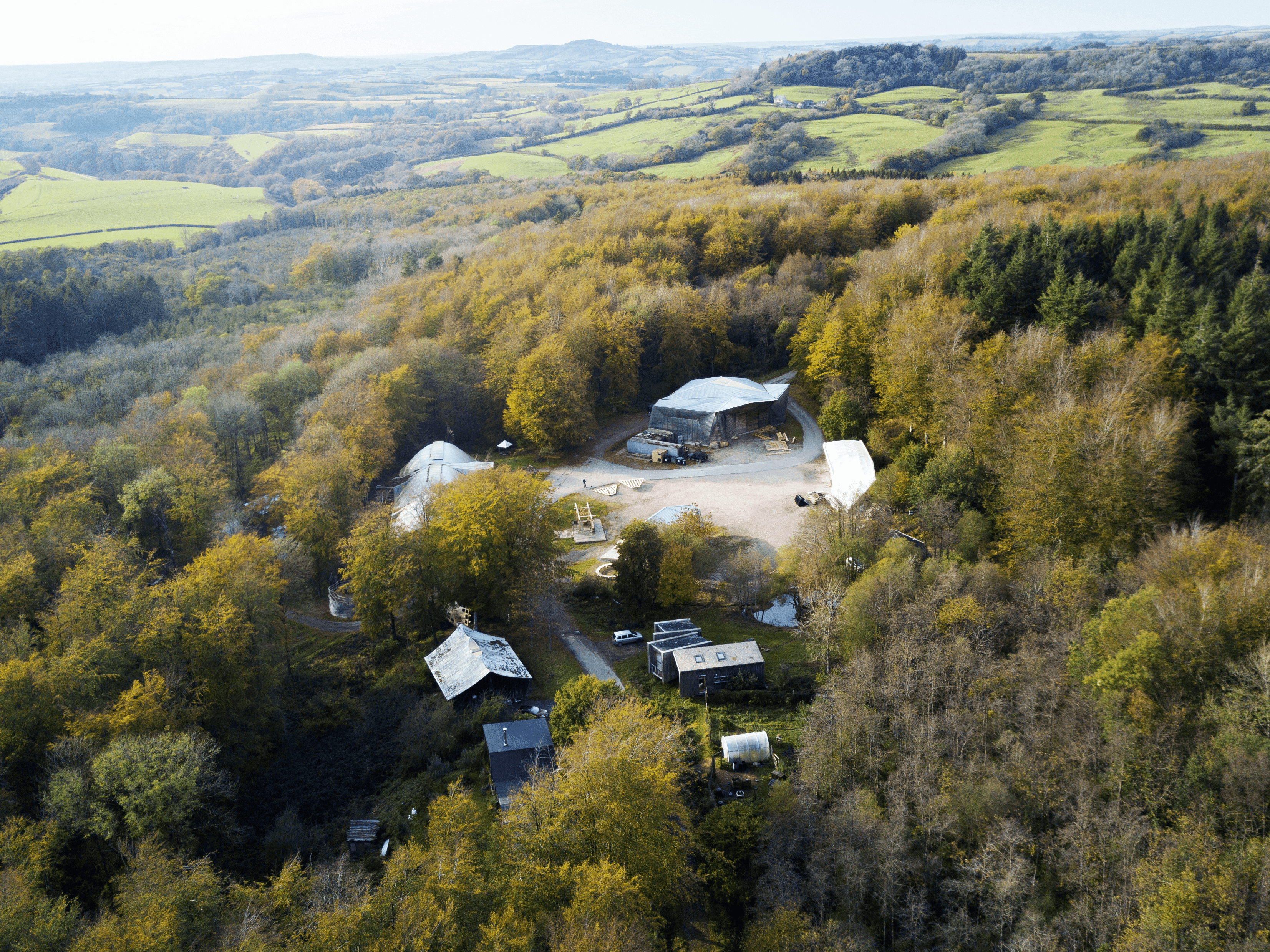 Aerial view of Hooke Park's woodland, central clearing and buildings in the Dorset landscape